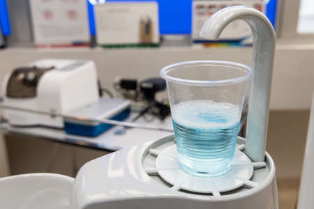 Mouth rinse in cup at dental clinic. Rinse before treatment for hygiene purpose.の写真素材