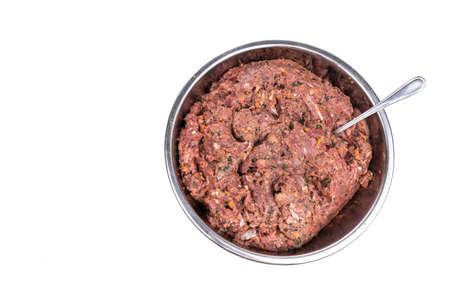 Overhead view on minced preparation of barf raw food recipe for dogs consisting meat, organs, fish,...