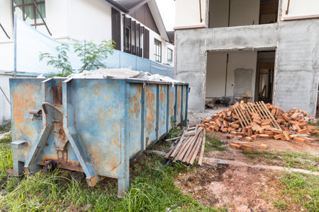 Garbage roro dumpter bin collects rubbish at construction site