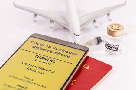 Concept of Covid-19 Immunity Passport for international travel, and digital certificte of vaccination on smart phone.の写真素材