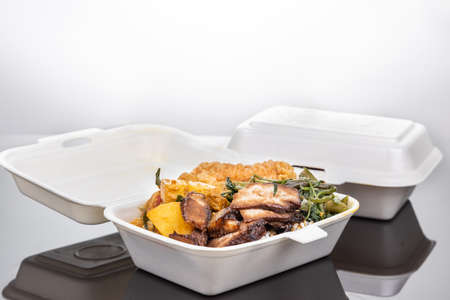 Biodegradable lunch box with rice, vegetable and food, convenient for food takeaway deliveryの写真素材