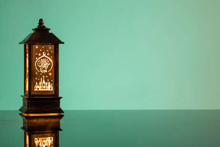 Eid Mubarak concepts with lamp inscribed with arabic text translated to english as Ramadhan is our light.の写真素材