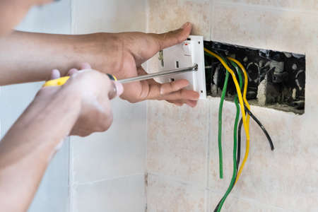Series of electrician install and mount electrical power socket onto wall