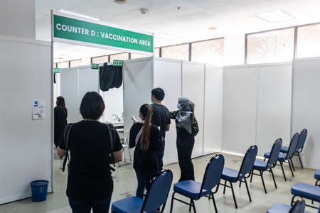 KUALA LUMPUR, MALAYSIA, July 16, 2021: People waiting for their turn to go into Covid-19 Vaccination area in Malaysia National Vaccination Program at WTCのeditorial素材