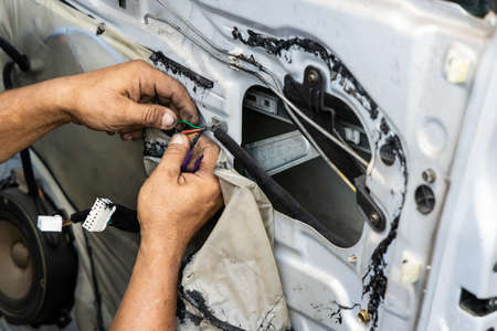 Auto technician diagnose and fixing wiring problem of car door
