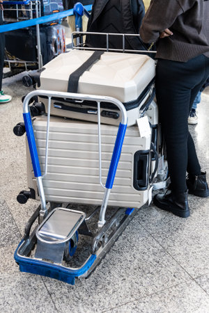 Luggages bags on trolley cart in airport departure terminal waiting for check-in before flightの写真素材