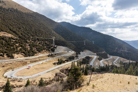 China G318 national highway 18 bends is one of the popular tourist attraction where the road winds uphill 26km from the county seat of Yajiang to Jianziwan Mountain Pass in Sichuan..の写真素材