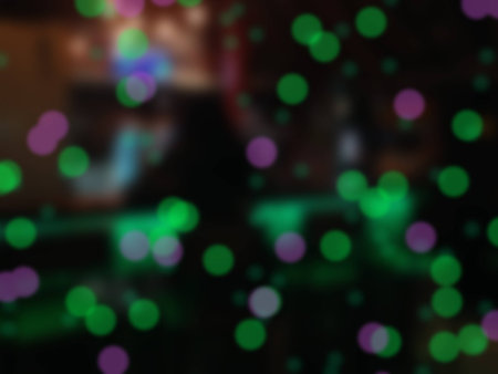 Atmosphere in bar, silhouette woman sit lonely in front of counter in bokeh light at night