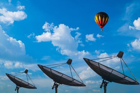 Hot air balloon with blue sky and satelliteの写真素材