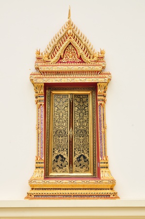 Ancient Golden carving wooden door of Thai temple in Bangkok, Thailand.の写真素材