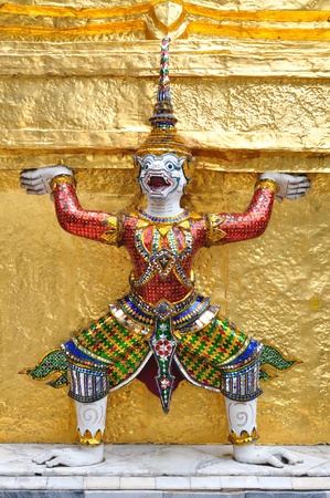 Antique Thai doll of monkey around golden pagoda in Thai temple in Royal palace.の写真素材