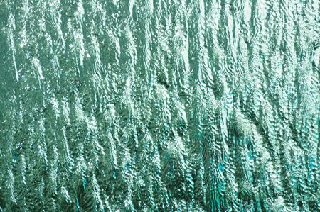 background of water flow on mirrorの写真素材
