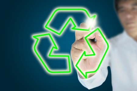 Hand of business man or male write recycle symbol with crystal ballの写真素材