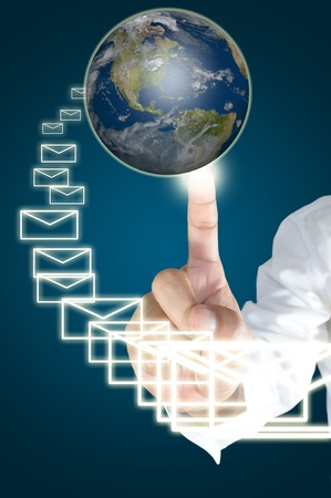 Hand of business man touch the earth globe and send the e-mailの写真素材