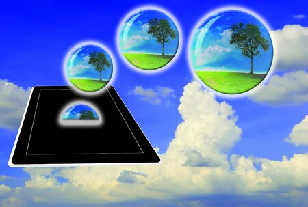 Crystal ball with lonely tree fly from touch pad or tabletの写真素材