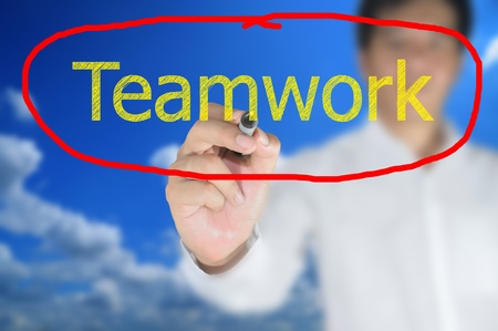 Business man write Teamwork on touch screenの写真素材