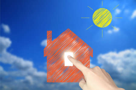 Hand of business man write a house and sun の写真素材