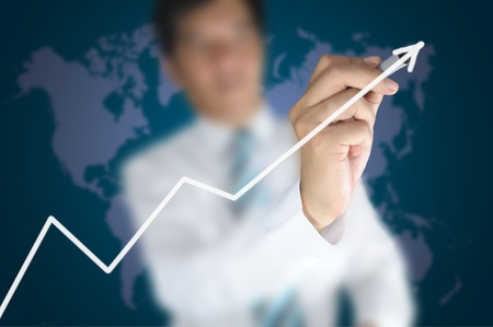 Hand of business man write a 3d business graph on tablet pc touch screenの写真素材