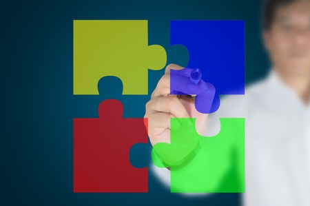 business man written Jigsaw pieces on the transparent boardの写真素材