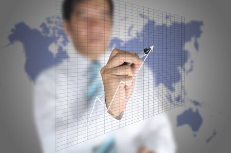 Business man write graph on touch screen displayの写真素材