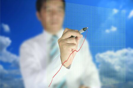 Business man write graph on touch screen displayの写真素材