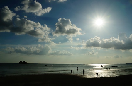 Silhouetted of people on the beach of Mae pim capeの写真素材