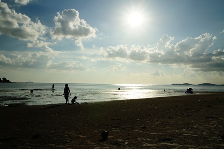 Silhouetted of people on the beach of Mae pim capeの写真素材