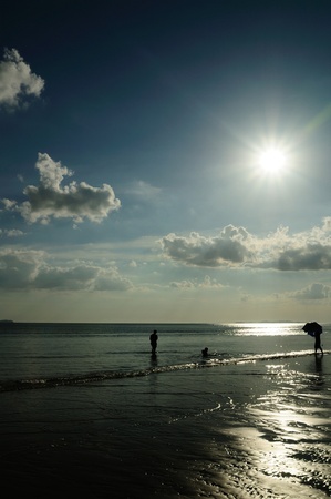 Silhouetted family at the beach of Mae pim capeの写真素材