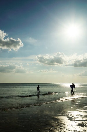 Silhouetted family at the beach of Mae pim capeの写真素材