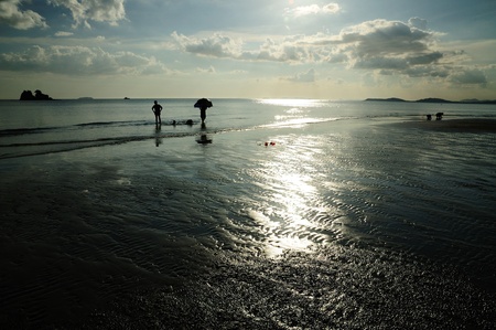 Silhouetted family at the beach of Mae pim capeの写真素材