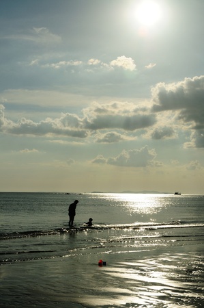 Silhouetted family at the beach of Mae pim capeの写真素材