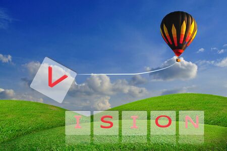 Hot air balloon pull V from the word vision in business conceptの写真素材
