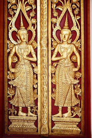 Ancient northern thai art of wood carving on wooden door. のeditorial素材