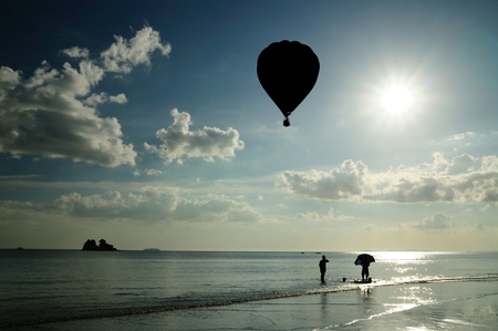 Silhouetted image of hot air balloon with beautiful blue sky and nice cloud in Thailand.の写真素材