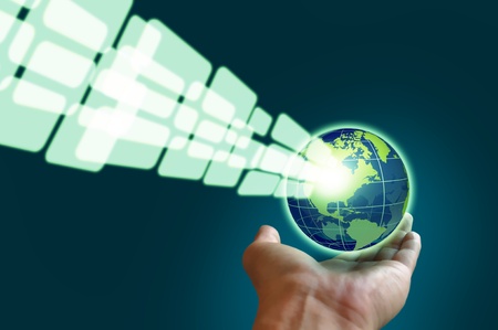 Male hand holding a glowing earth globe in globalization conceptの写真素材