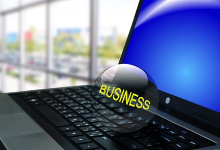 Crystal ball of the word "business" on notebook or laptop computerの写真素材