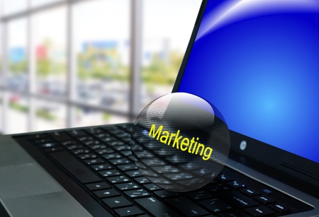 Crystal ball of the word "marketing" on notebook or laptop computerの写真素材