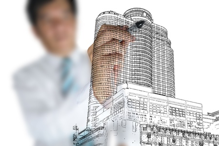 Hand of Business man draw modern buildingの写真素材