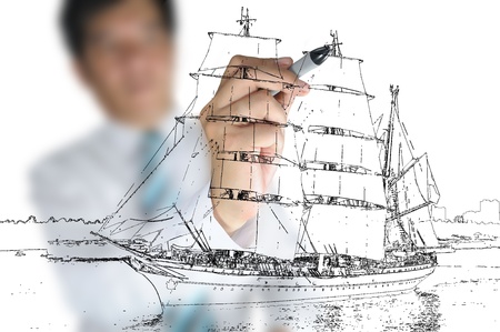 Hand of Business man draw sailing ship の写真素材