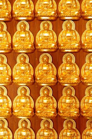 Pattern of golden wood carving buddha on chinese temple wallの写真素材