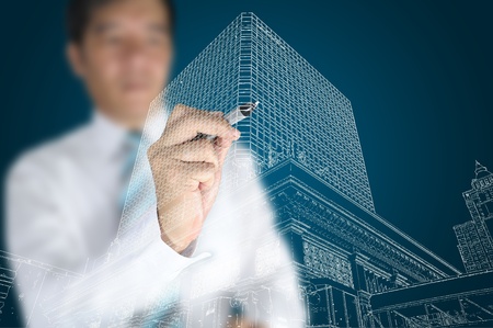 Businessman draw modern building and cityscapeの写真素材