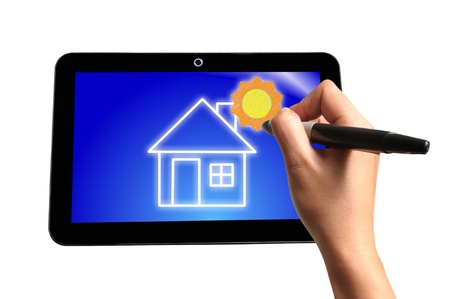 Hand of Business Man Draw House and Sun on Touch screen of Tablet PCの写真素材