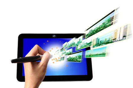 Hand of Business Man write on Touch screen of Tablet PC with Flying Streaming Image and Video.の写真素材