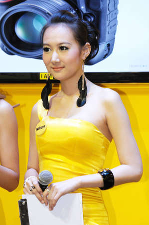 BANGKOK, THAILAND - FEB.19: Unidentified female, presenter of Nikon booth, presenting Nikon products in Thailand Photofair 2012 on FEB.19, 2012  at BITEC Exhibition center in Bangkok, Thailand. のeditorial素材