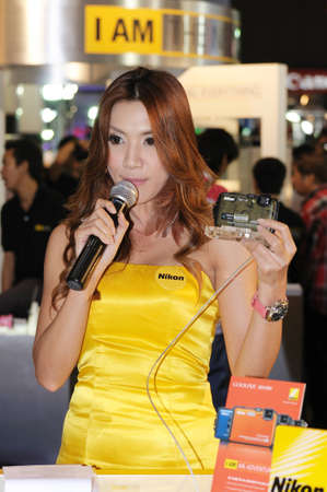 BANGKOK, THAILAND - FEB.19: Unidentified female, presenter of Nikon booth, presenting Nikon products in Thailand Photofair 2012 on FEB.19, 2012  at BITEC Exhibition center in Bangkok, Thailand.のeditorial素材