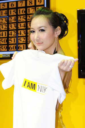 BANGKOK, THAILAND - FEB.19: Unidentified female, presenter of Nikon booth, presenting Nikon products in Thailand Photofair 2012 on FEB.19, 2012  at BITEC Exhibition center in Bangkok, Thailand.のeditorial素材