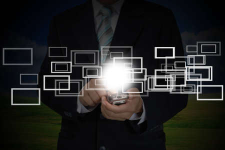 Hand of Business Man Pushing touch screen of mobile smart phoneの写真素材