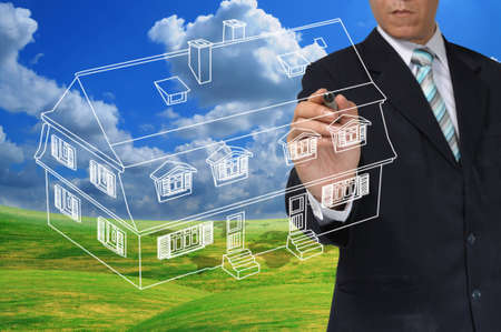 Business Man Drawing house or estate as real estate conceptの写真素材