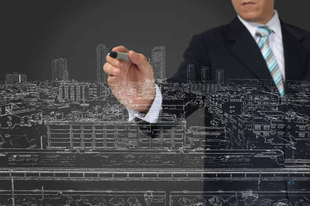 Business Man Drawing building and seascapeの写真素材