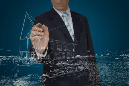 Business Man Drawing building and seascapeの写真素材